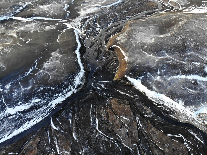 High angle view of frozen stream