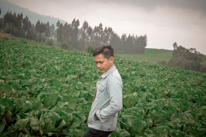 Young man standing in field