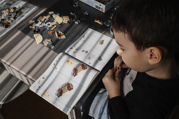 21.03.2022. batumi, georgia. boy child manually folds lego constructor at the table.star wars. 