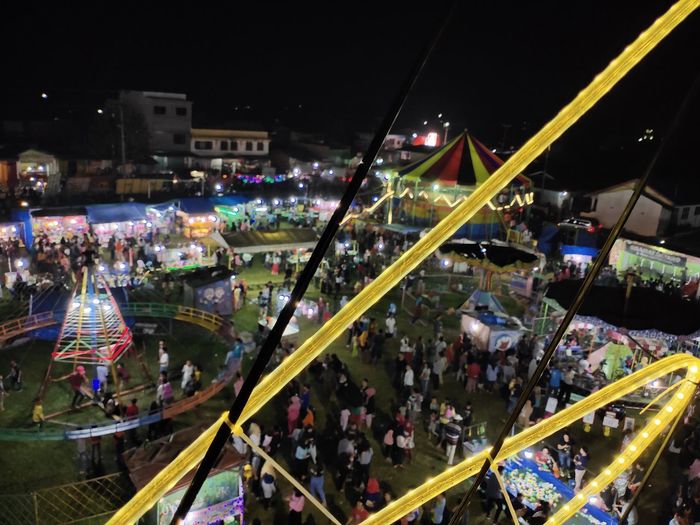 High angle view of illuminated carousel at night