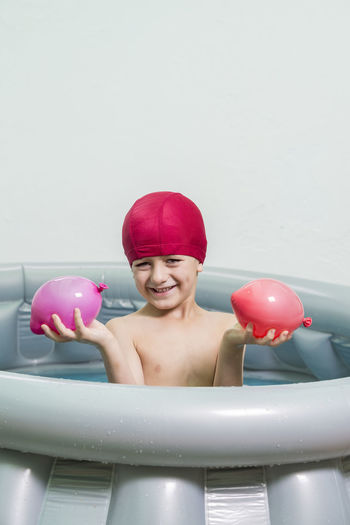 Portrait of smiling boy in inflatable pool