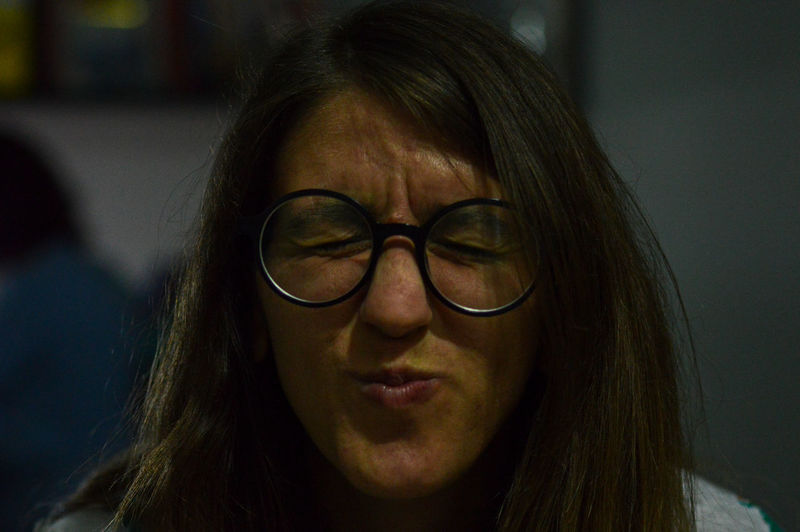 Close-up of woman wearing eyeglasses making face