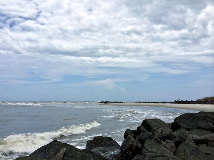 Scenic view of sea against cloudy sky