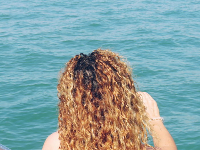 Rear view of woman by sea
