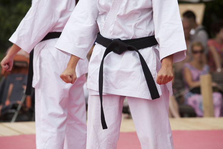 Midsection of women standing during karate