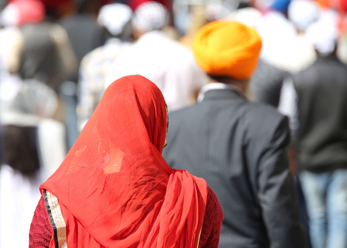 Bright red veil of a sikh woman during a religious celebration in a park