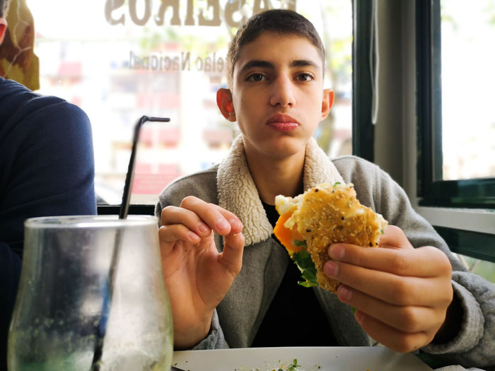 Portrait of men eating food in restaurant