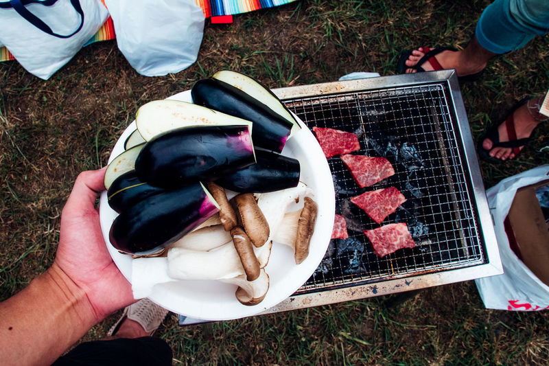 Cropped image of people holding food