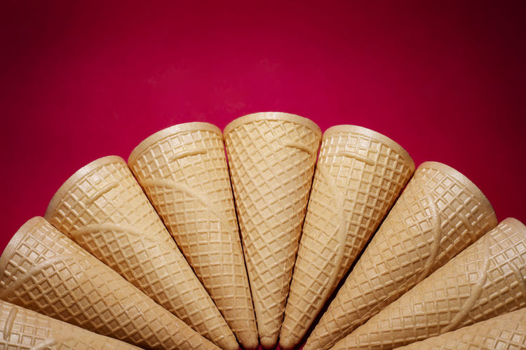 A group of empty waffles cones on red background