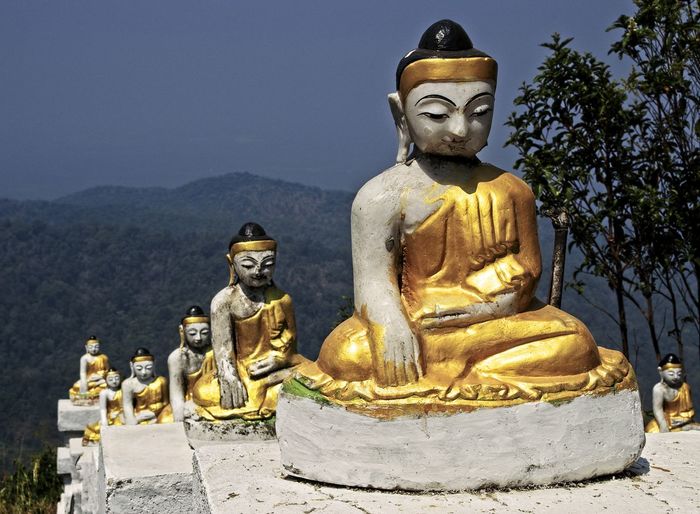 Statue against temple against mountain