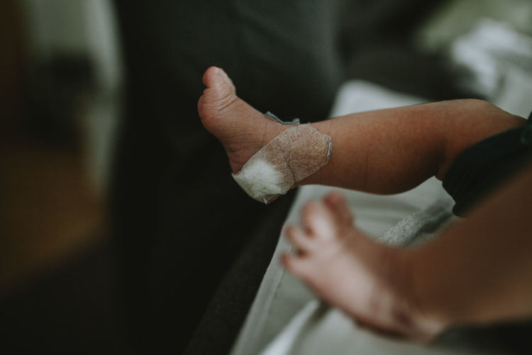 Low section of baby boy with bandage