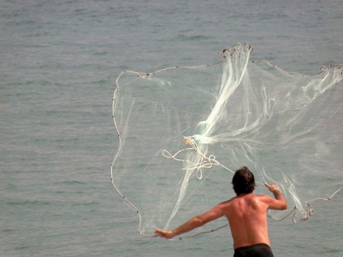 Man throwing fishing net