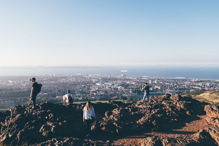 Rear view of hikers on top of cliff