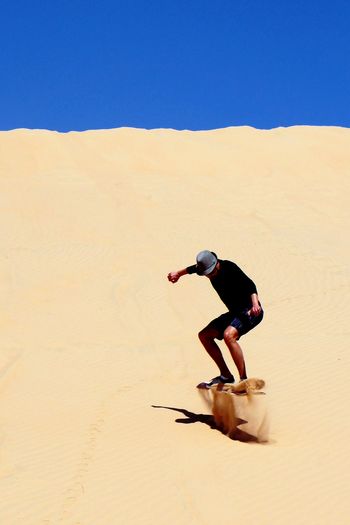 Full length of woman walking on desert