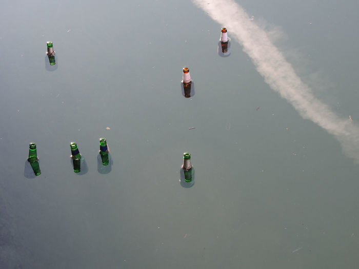 High angle view of bottles floating on water