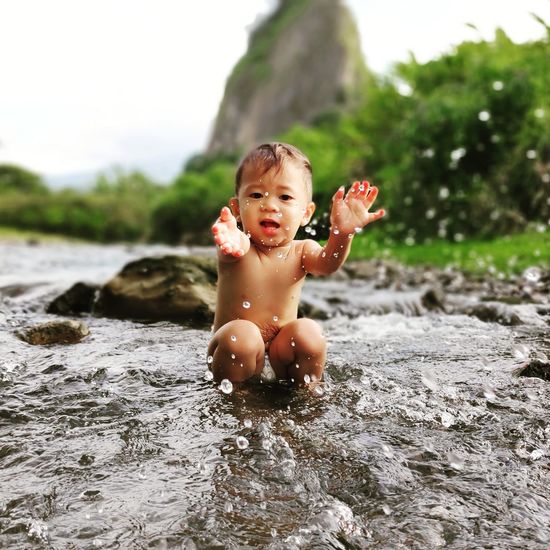 Portrait of shirtless boy in water