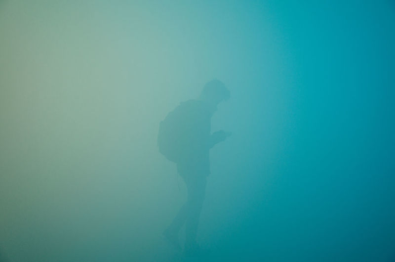 Silhouette man swimming in sea