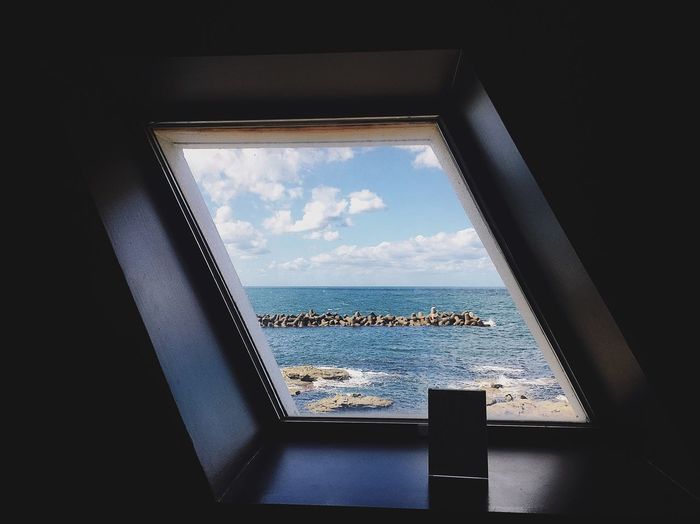 View of sea seen through window