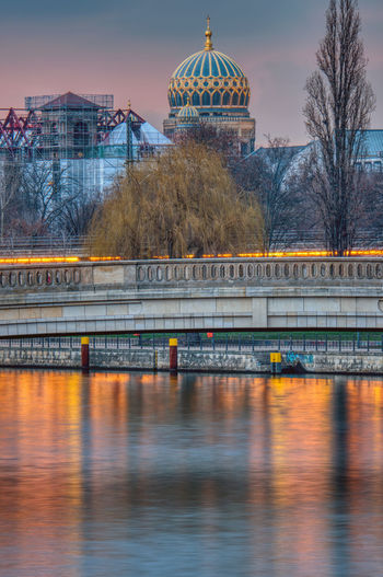 The river spree in berlin at sunset with the cupola of the new synagogue in the back