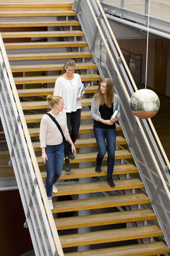 Three university student on stairs