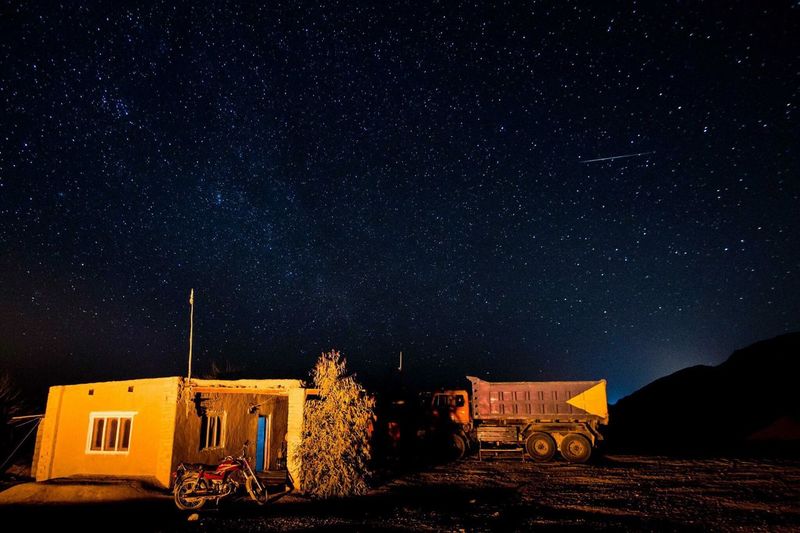 Old rustic house against starry sky