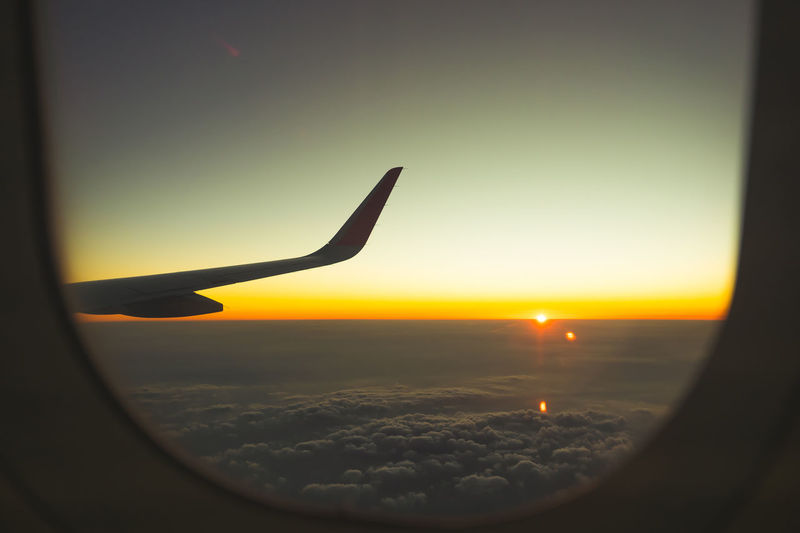 Scenic view of sunset seen through airplane window