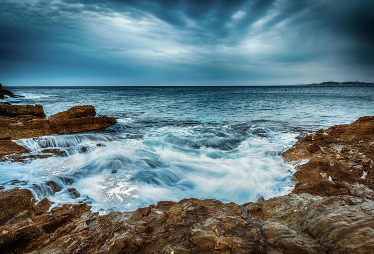 Scenic view of sea against dramatic sky