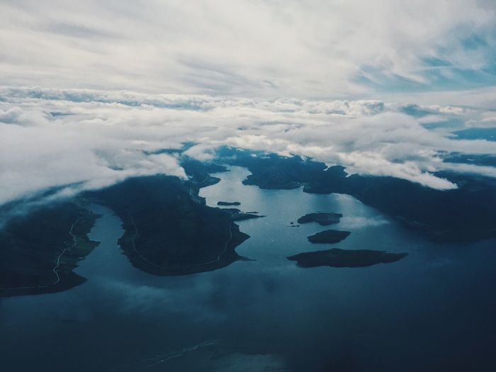 Coast of norway, mysterious wilderness, aerial view, fjord, islands, white clouds, horizon 