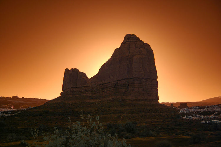 Rock formations against sky during sunset