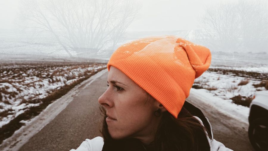 Portrait of mid adult woman looking away during winter