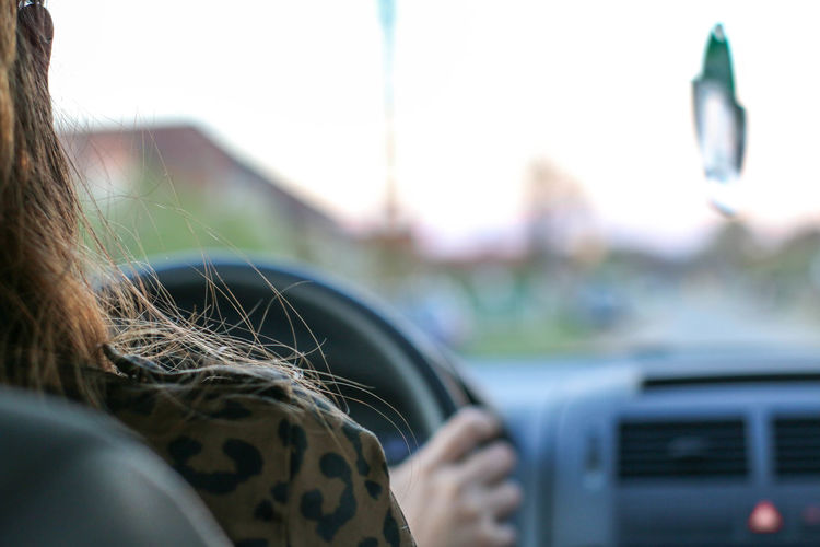 Close-up of woman driving in car