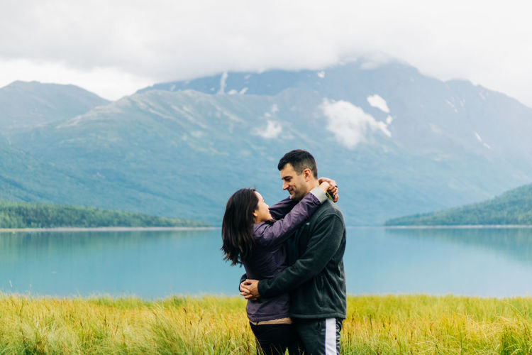 Full length of couple on lake against mountains