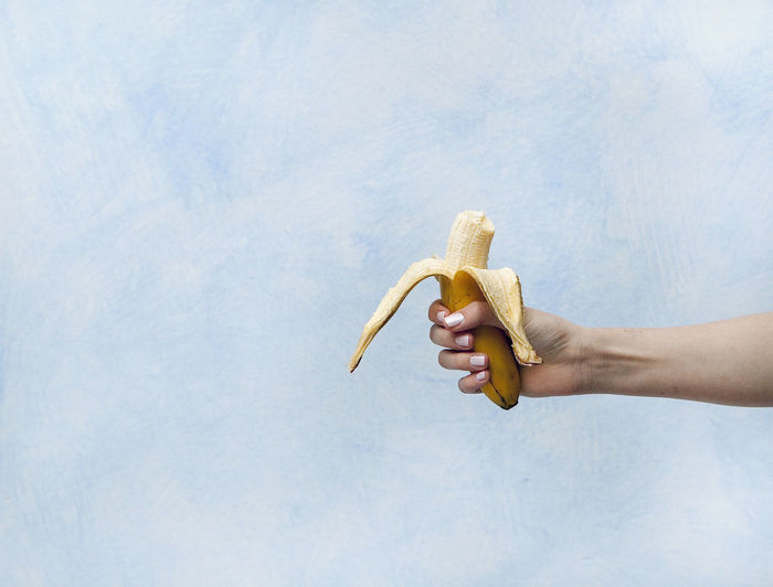 Close-up of hand holding banana