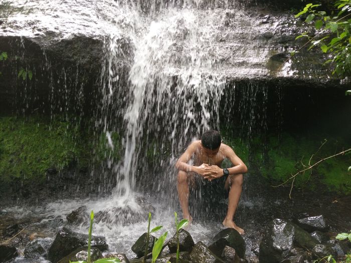View of waterfall with rocks in water