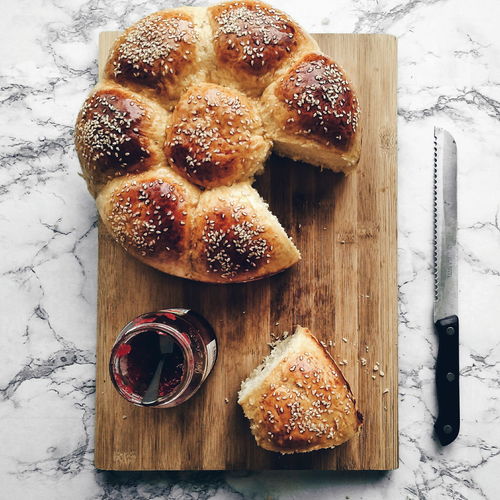 High angle view of bread and jam on cutting board