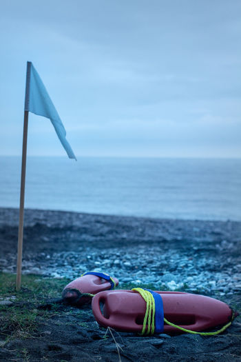 Low section of person on beach against sky