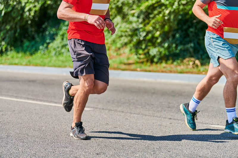 Rear view of man running on road