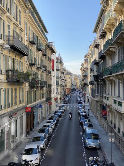 Cars on road amidst buildings in city