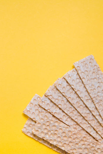 Close-up of bread on table against yellow background