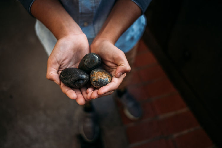 Portrait of child holding rocks in their hands