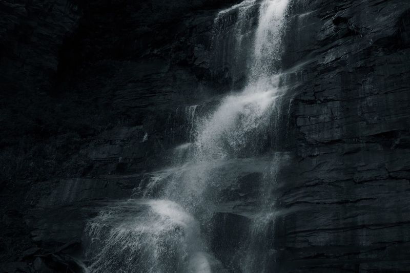 Close-up of waterfall against black background