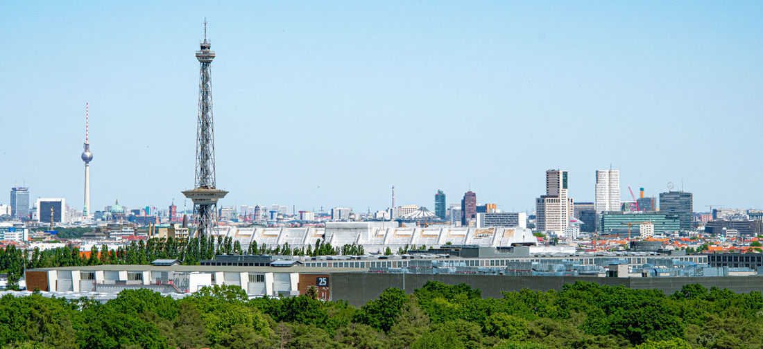 Buildings in city against clear sky