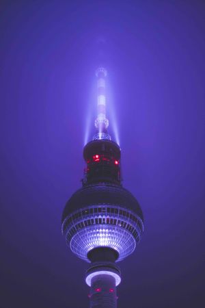 LOW ANGLE VIEW OF ILLUMINATED TOWER