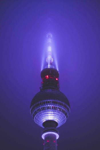 LOW ANGLE VIEW OF ILLUMINATED TOWER