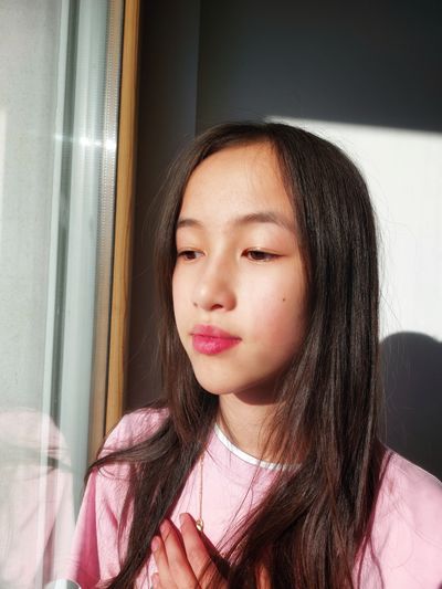 Sad girl looking out the window