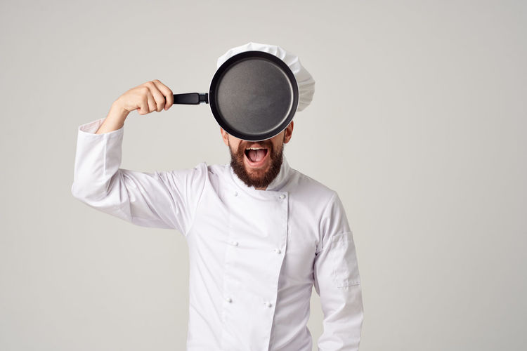 Chef standing against white background