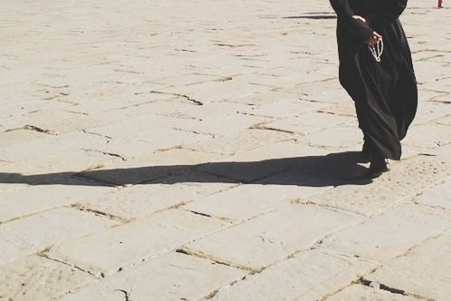 Low section of woman standing on shore