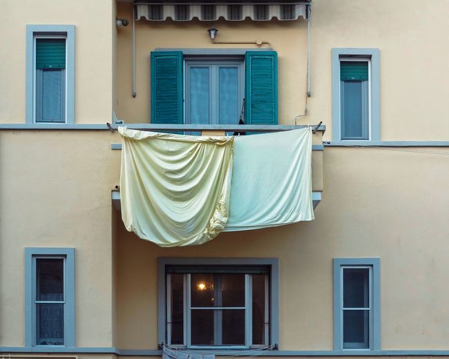 Clothes drying outside house against building