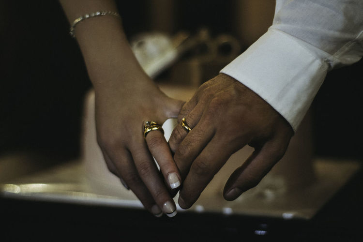 Close-up of couple showing rings