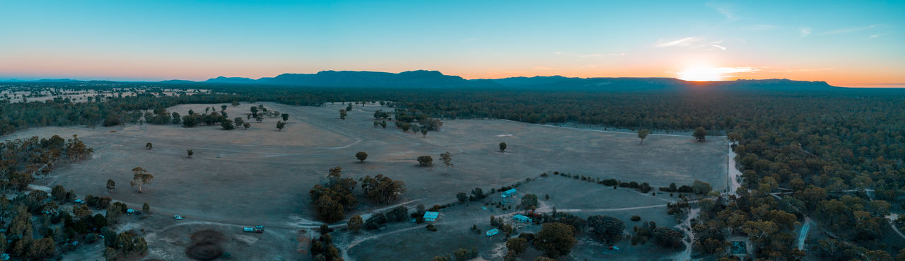 Wide aerial panorama of grampians mountains, farmland, and forest at sunset. victoria, australia